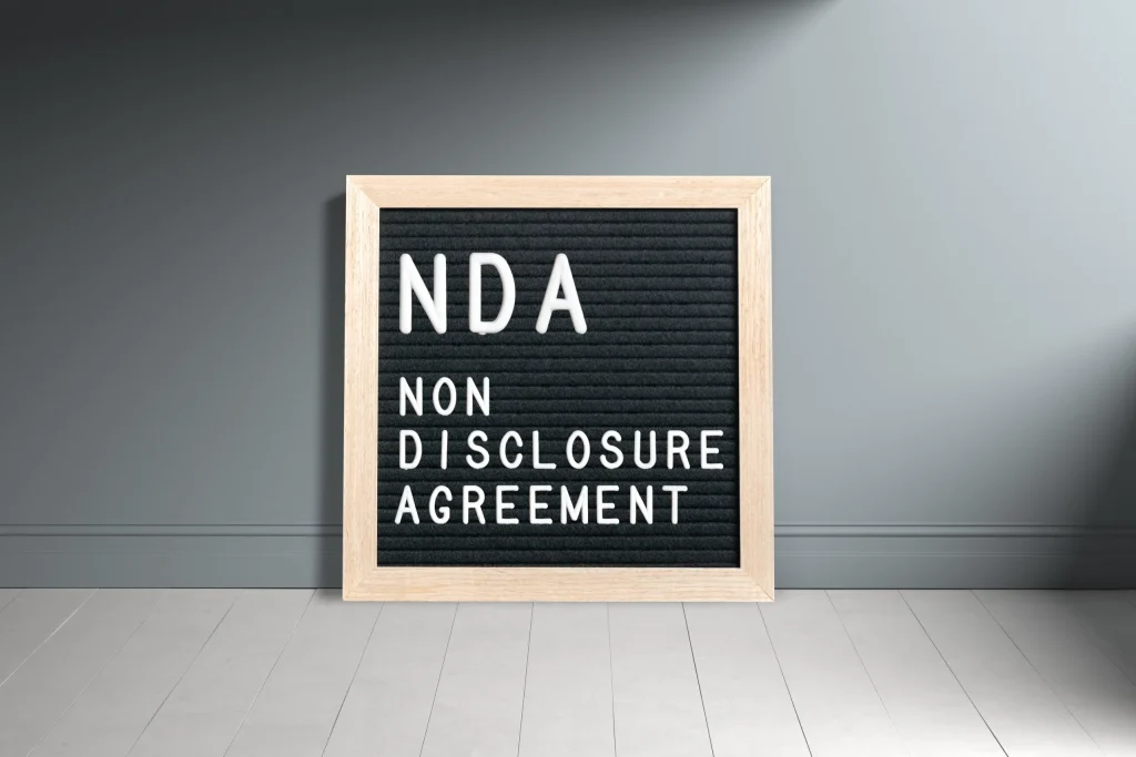 A sign that says NDA Non-Disclosure Agreement. It's best to contact a non-compete agreement attorney in San Antonio before making the decision to sign an NDA presented to you by an employer.