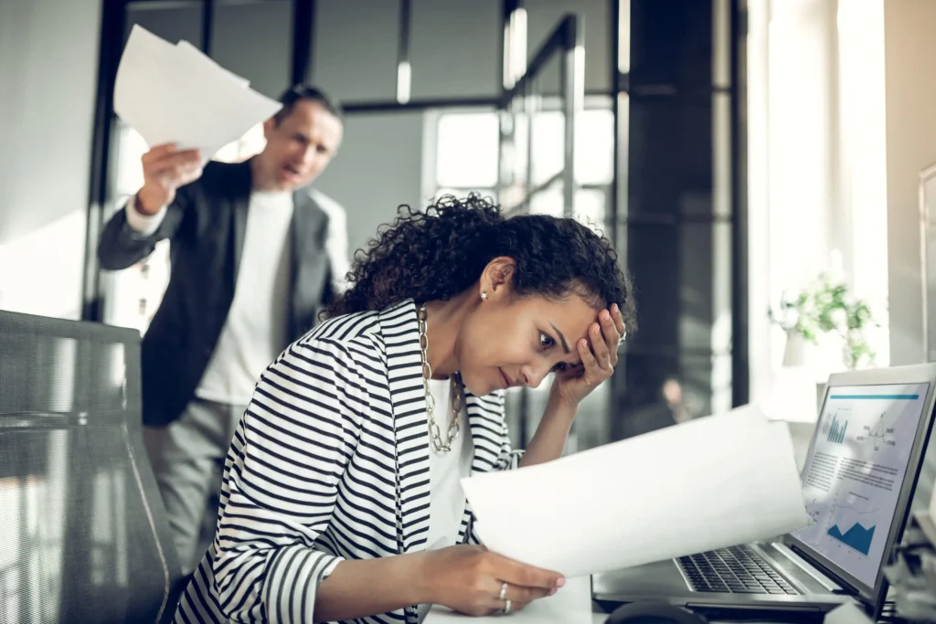 A female experiencing retaliation at work in San Antonio, TX after dealing with sexual harassment at work. If this has happened to you, contact an employment discrimination lawyer.