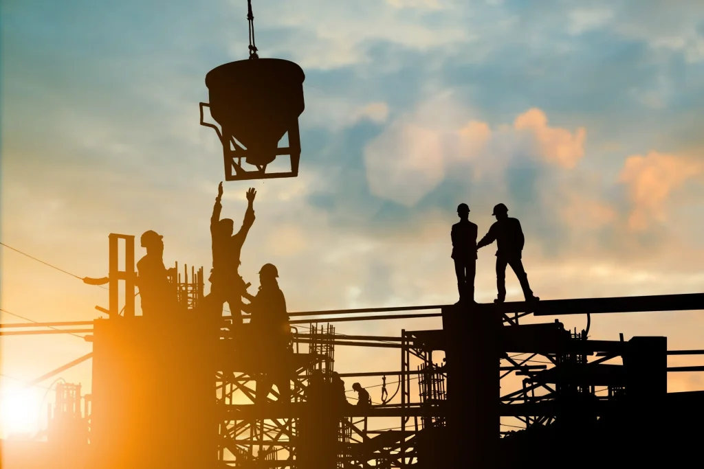 Labor workers standing and checking on a job they're working on. If fair wages and employment conditions are a concern it is necessary to contact a skilled Austin labor law attorney.