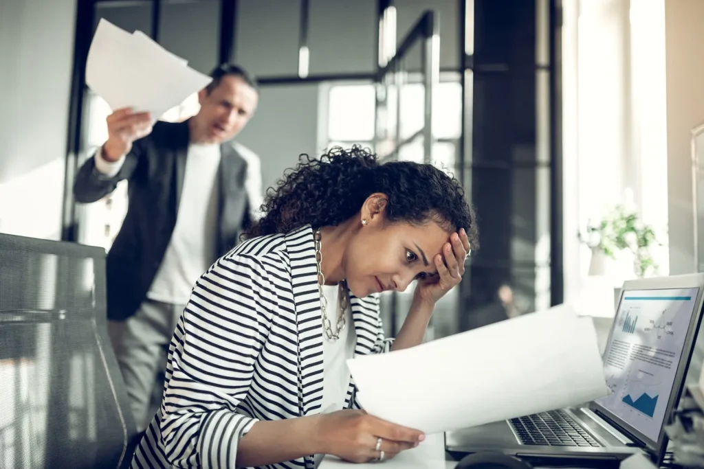 Woman being yelled at by boss.