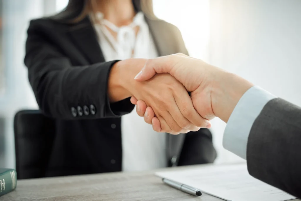 Woman shaking hands with employer.