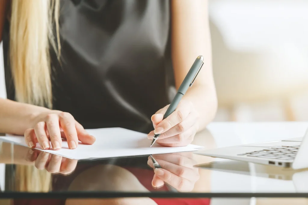 Woman filling out paperwork.