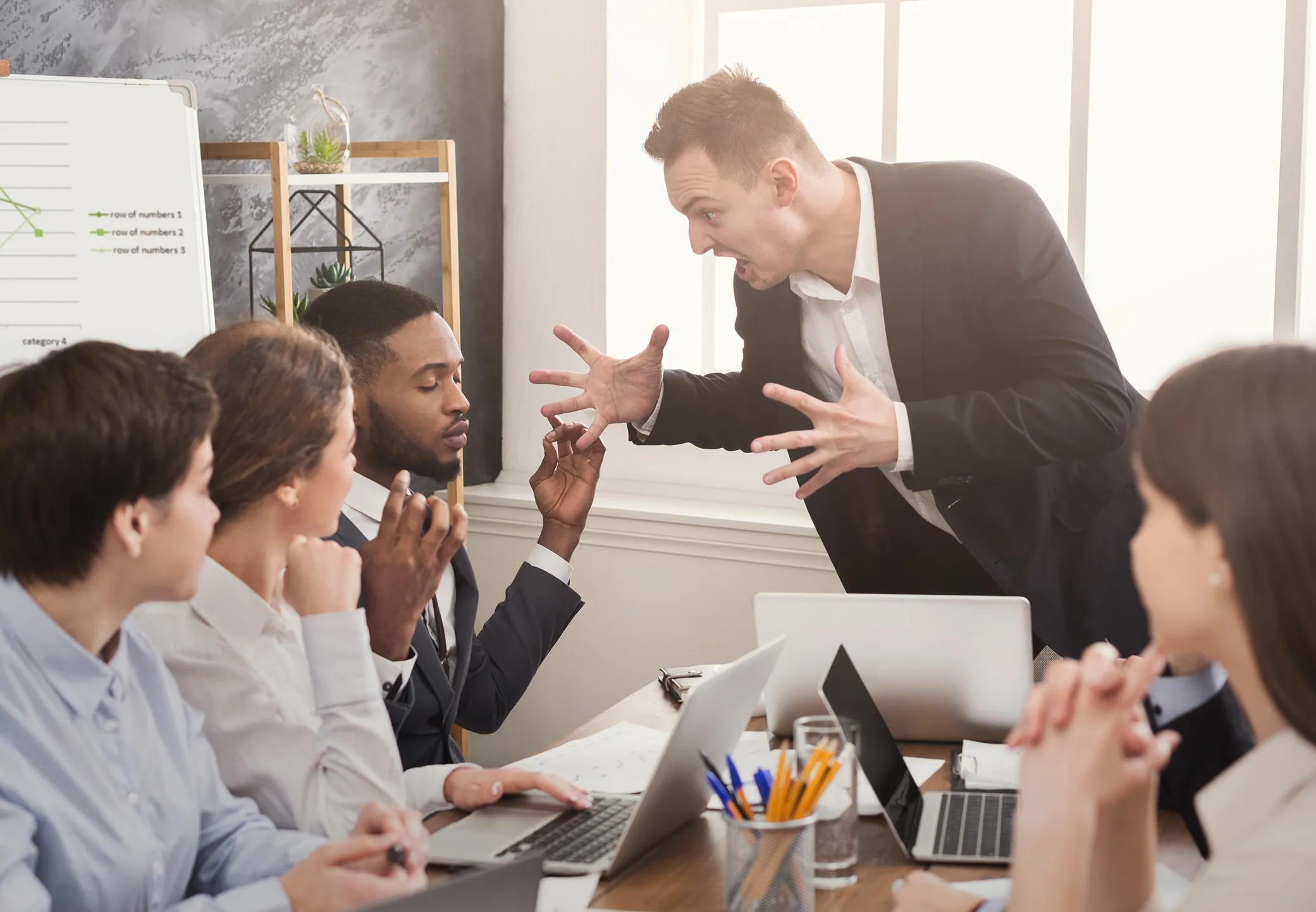 A boss yelling at his employees
