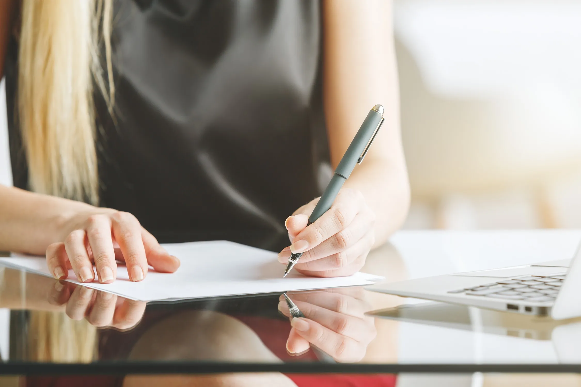 A woman signing a contract.