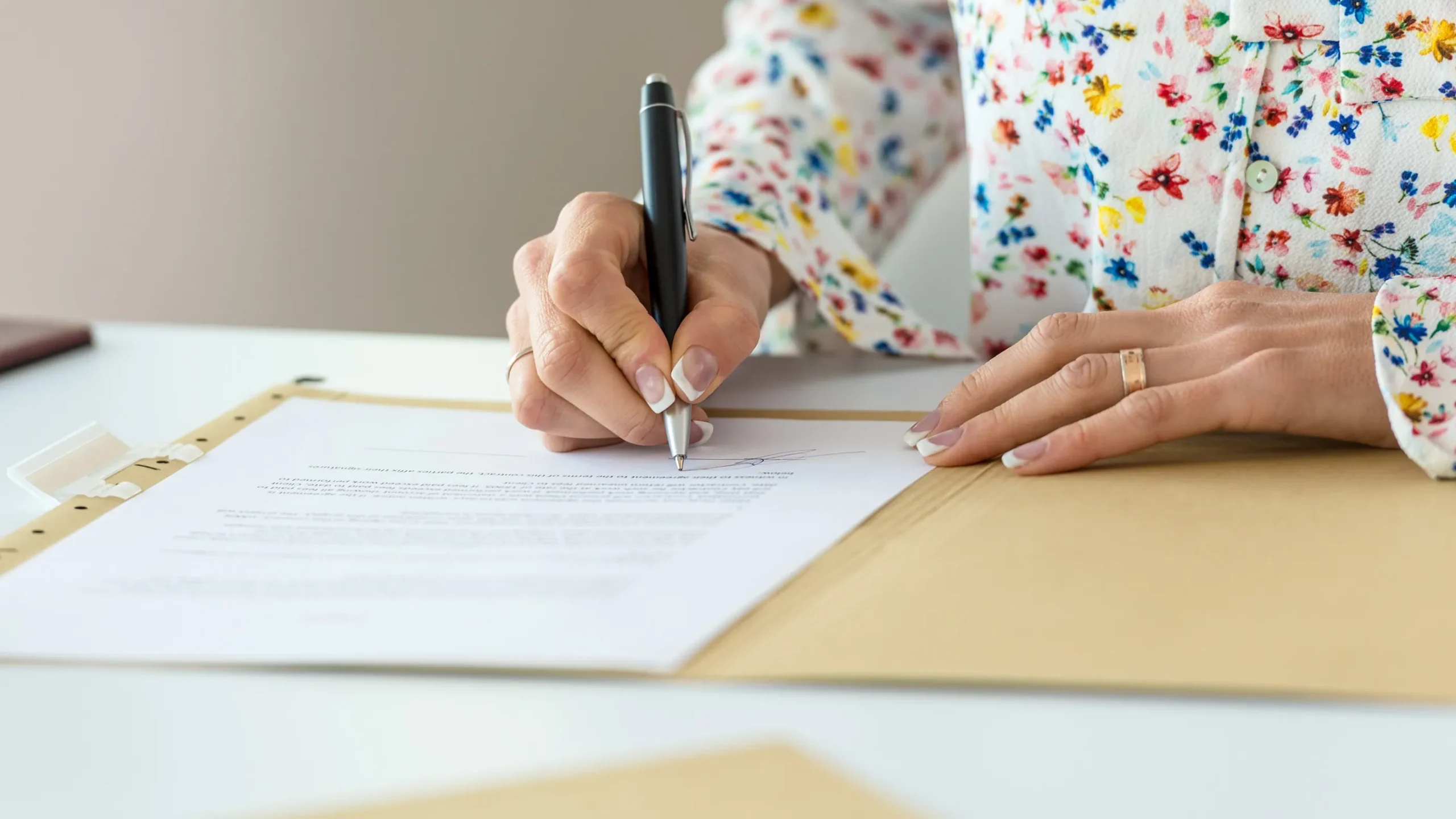 A woman signing some papers. 