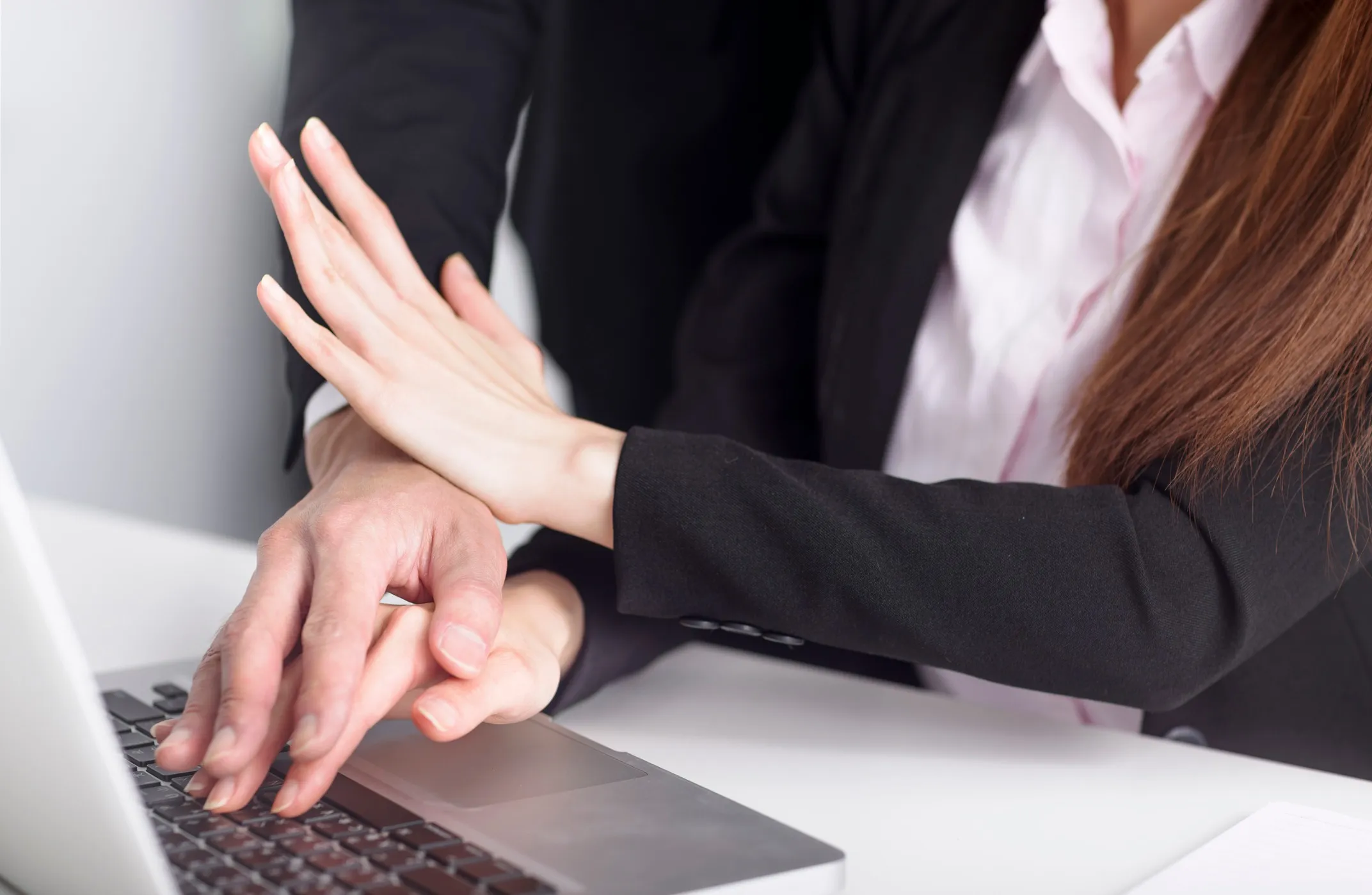 A woman blocking a man's hand.