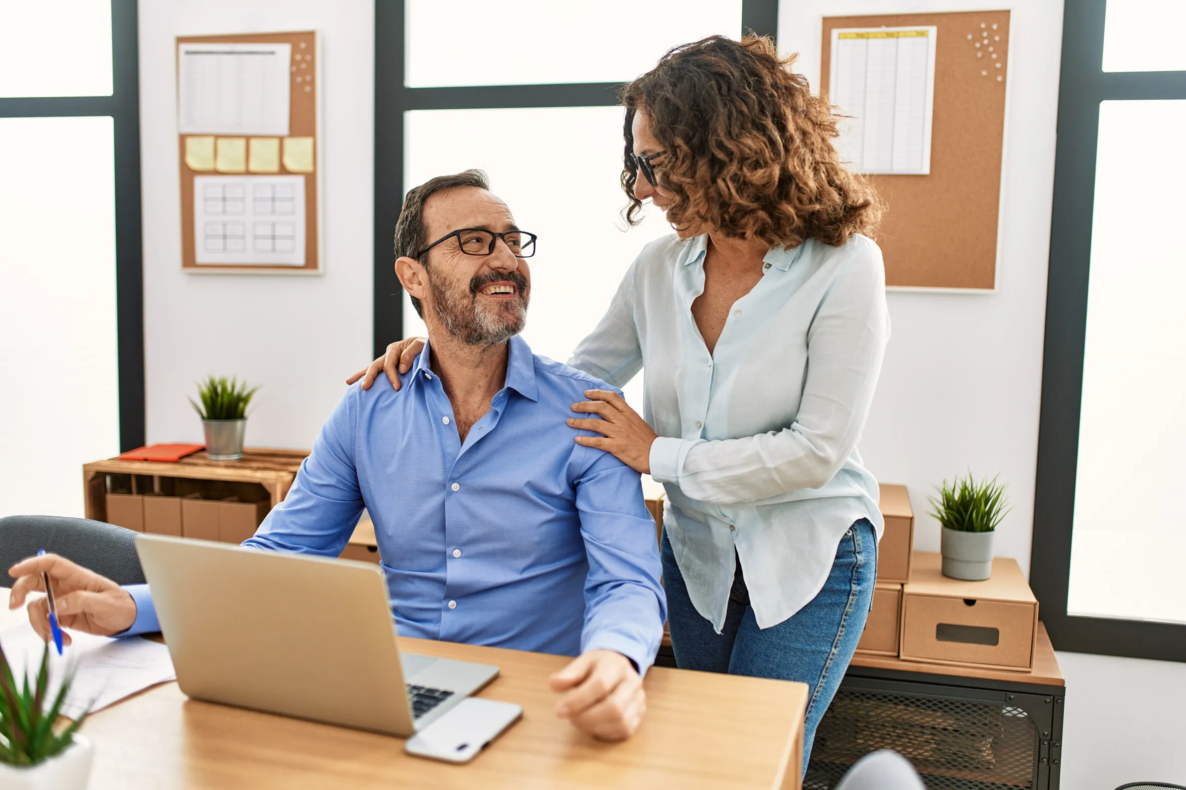 A female employee inappropriately touching man's shoulders.